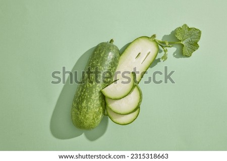 Minimal scene with fresh winter melon placed on pastel background. Winter melon (Benincasa hispida) is low in calories and are ideal for people aiming for weight loss and those with diabetes Royalty-Free Stock Photo #2315318663