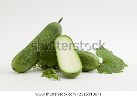 Against a white background, fresh winter melon and green leaf isolated. Winter melon contains a high amount of vegetable oil, which is very beneficial for skin and hair Royalty-Free Stock Photo #2315318671