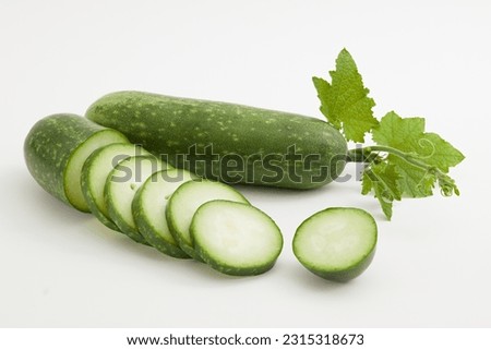 Winter melon known as wax gourd or ash gourd cut into slices and leaf decorated on a white background. Winter melon contains a high amount of vegetable oil, which is very beneficial for skin and hair Royalty-Free Stock Photo #2315318673