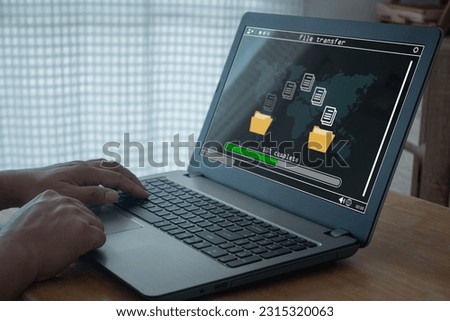Transfer files data system relocation concept, Person hand using laptop computer waiting for transfer file process with loading bar icon on screen. Data transfer,  Backup data, Exchange file, DMS. Royalty-Free Stock Photo #2315320063