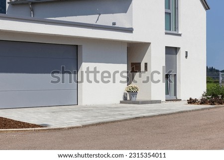 garage carport on a modern house facade in south germany city at summer sunshine and blue sky Royalty-Free Stock Photo #2315354011