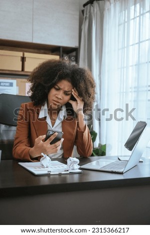Tired african american business woman working with audit, balance sheet, investing activities, safety stock, net loss, business risks, accumulated depreciation, factory overhead, accrued expense Royalty-Free Stock Photo #2315366217