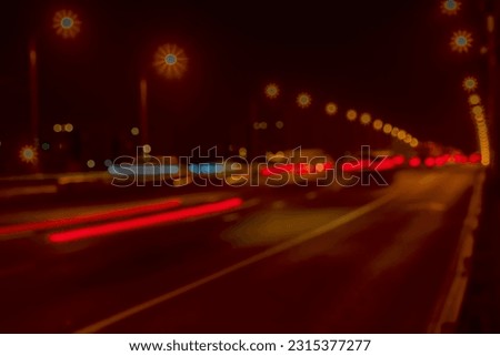Urban street night traffic. Blurred auto with brake lights, city street lights  Selective focus