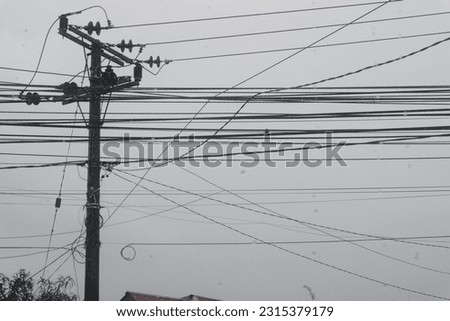 electric pillars with lots of high voltage wires are located by the side of the road Royalty-Free Stock Photo #2315379179