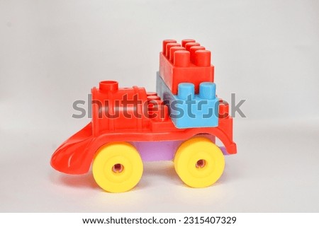 A photo of a colorful children's toy car in the photo with front angle