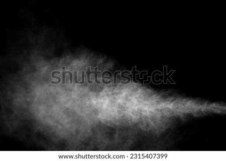 Close-up of steam or abstract white smoke rising above. from humidifier spray isolated on a black background Royalty-Free Stock Photo #2315407399