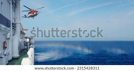     Air-sea rescue operations. Red rescue helicopter and Oil Tanker Ship . rescue team. The Coast security. The accident on the water. Ship have Emergency Accident. Training air sea recue operations.  Royalty-Free Stock Photo #2315428311