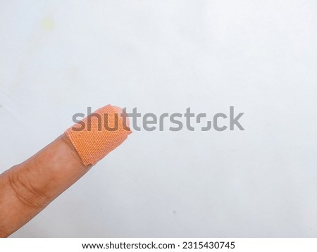 Forefinger of a woman hand with a band aid isolated on white background. Space for text