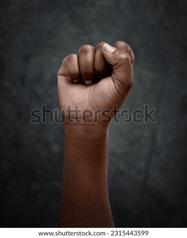 Equality, protest and hand fist for justice or solidarity, human rights and support for the community. Fight for change, power. and revolution for freedom or empowerment on dark or black background