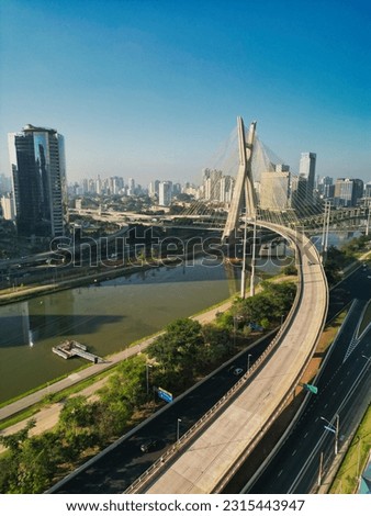 2023 view of the Pinheiros river with modern buildings beside it and the famous Octavio Frias de Oliveira bridge in the city of São Paulo. Royalty-Free Stock Photo #2315443947