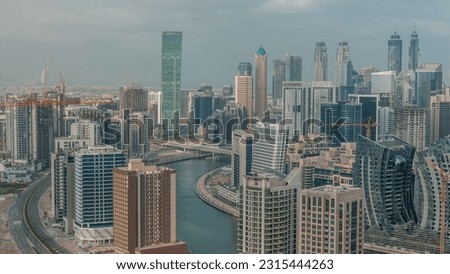 Skyline with modern architecture of Dubai business bay towers morning . Aerial view with canal and construction site during sunrise Royalty-Free Stock Photo #2315444263