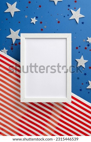 Celebrate spirit of Independence Day. Vertical top view showcases allure of symbolic adornments: stars, luminous confetti, photo frame on American flag background with space, ideal for text or picture
