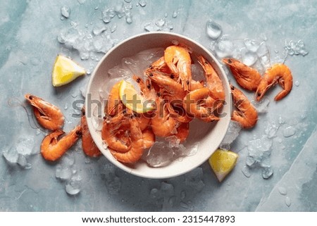 Healthy food. Fresh shrimps with ice on plate on light background top view Royalty-Free Stock Photo #2315447893