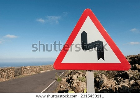 Bends in the road, triangular road sign.