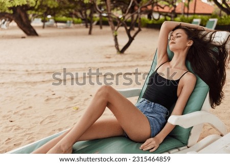 smiling woman beach resort sea ocean lifestyle sunbed sand lying bikini