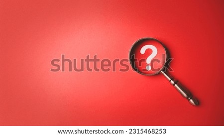 Magnifying glass and question mark icon symbol on red paper background with copy space. Problem solving troubleshooting education concept. Royalty-Free Stock Photo #2315468253