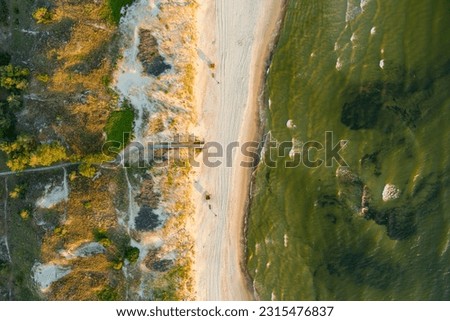 Aerial view of the Baltic Sea shore line near Klaipeda city, Lithuania. Beautiful sea coast on sunny summer day. Royalty-Free Stock Photo #2315476837