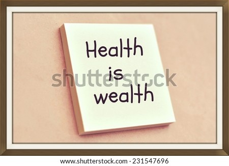 Text health is wealth on the short note texture background