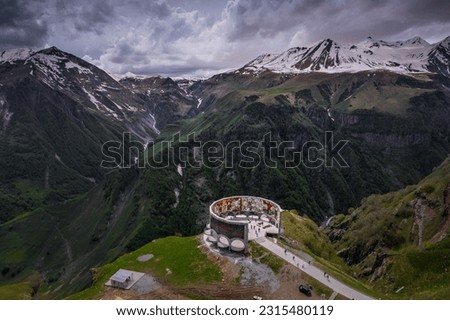 Aerial view of Russia–Georgia Friendship Monument located on the Georgian Military Highway between the ski resort town of Gudauri and the Jvari pass, overlooking the Devil's Valley in the Caucasus. Royalty-Free Stock Photo #2315480119