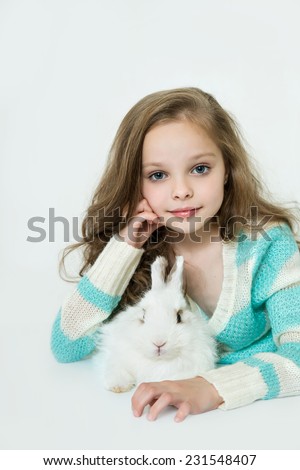 Happy little girl with rabbit