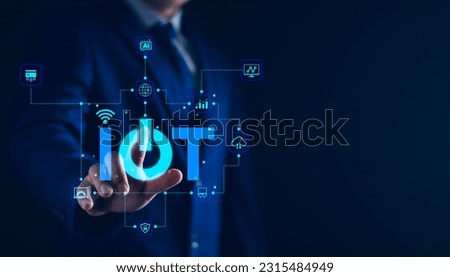 Smart business IOT, internet of things concept. Businessman touching IOT icon on virtual screen, connected internet network to access AI intelligence, business analytics, internet investing. Royalty-Free Stock Photo #2315484949