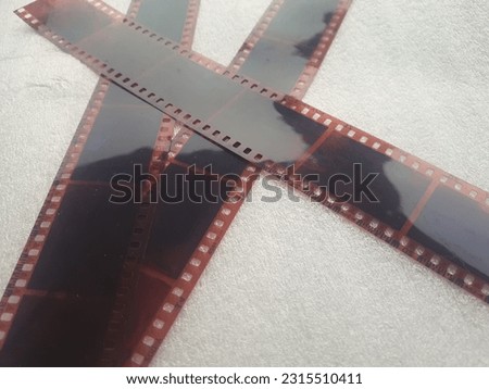 Photo cliches or film negatives on a white background. 35mm film negatives used to be popular with photographers using older digital cameras.