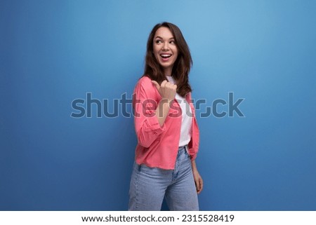 long-haired brunette young adult in a shirt with cheerful emotions on an isolated background