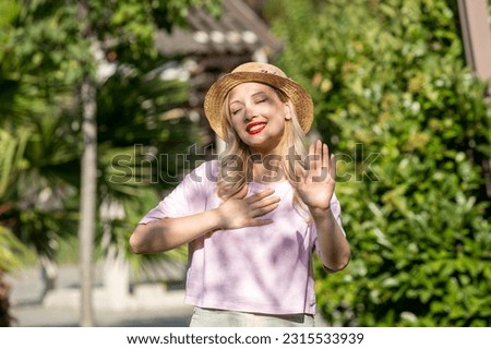 cute girl in the summer at the park young lovely pretty blonde girl in hat blessed Royalty-Free Stock Photo #2315533939