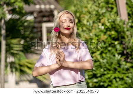 cute girl lovely pretty young blonde girl in hat in the summer at the park with lips Royalty-Free Stock Photo #2315540573