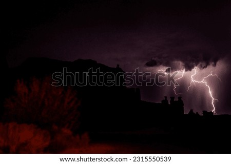 A nocturnal storm with lightning and thunder to light up the night. Arches National Park Utah. The park has over 2,000 natural stone arches, hundreds of soaring pinnacles, massive rock fins, and giant
