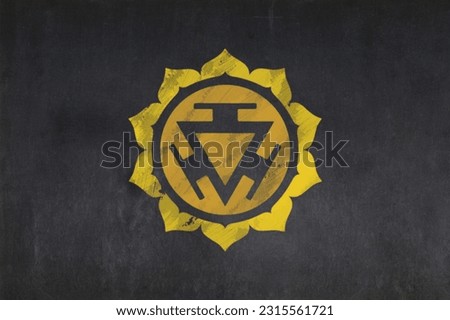 Blackboard with the symbol of the Solar Plexus Chakra (Hinduism, Buddhism and Jainism) drawn in the middle. Royalty-Free Stock Photo #2315561721