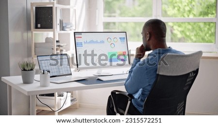 African Businessman Using Analytics Data KPI Dashboard Tech Royalty-Free Stock Photo #2315572251
