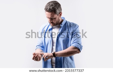 man measuring pulse on wrist. mature man with pulse on wrist. man check pulse on wrist Royalty-Free Stock Photo #2315577337