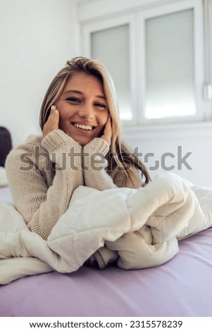 Young woman, wake up portrait in bedroom after sleeping in the morning. Peace, bed relax and comfort of happy female awake after sleep on comfortable pillow and blankets for healthy rest.