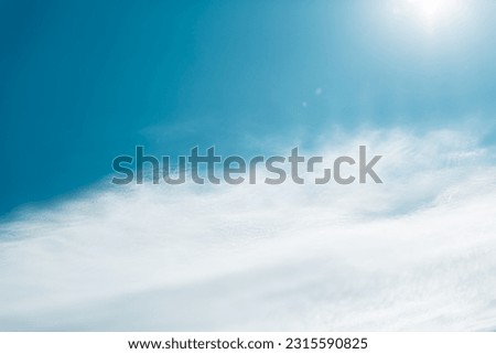 Fantastic soft white clouds against blue sky. Beautiful blue sky background. Golden heaven light Hope concept abstract blurred background from nature scene outdoor vacation trip
