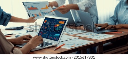 Panorama shot analyst team utilizing BI Fintech to analyze financial report with laptop. Businesspeople analyzing BI power dashboard displayed on laptop screen for business insight. Scrutinize Royalty-Free Stock Photo #2315617831