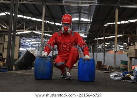 Worker maintenance  or scientist industry wearing protective safety uniform, white glove and gas mask to work with a  two barrel of oil.