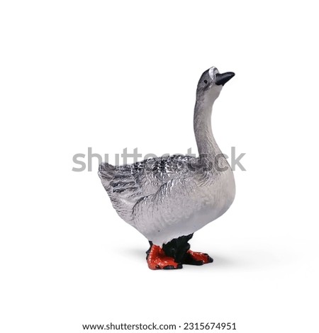 Close-up of a miniature toy duck side view against a white background