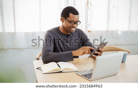 Portrait of happy business African black man with casual cloths working in home office desk using phone computer. Small business employee freelance online sme marketing e-commerce telemarket banner