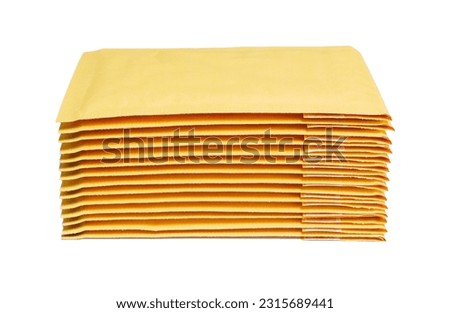 Close-up of yellow padded mailers stacked on a white background. Royalty-Free Stock Photo #2315689441