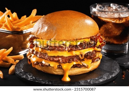 Smash burger with soda and fries in black backgraund Royalty-Free Stock Photo #2315700087