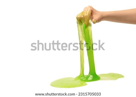Green slime toy in woman hand wwith green nails isolated on a white background.  Royalty-Free Stock Photo #2315705033