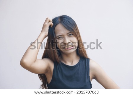 Woman having itchy skin on the head