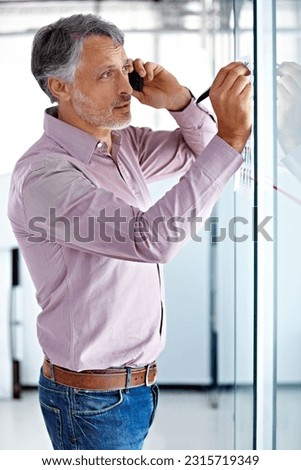 Senior man, professional phone call and writing on glass board, ideas and agenda, brainstorming for ad campaign. Communication, problem solving and business, male worker plan at advertising startup Royalty-Free Stock Photo #2315719349