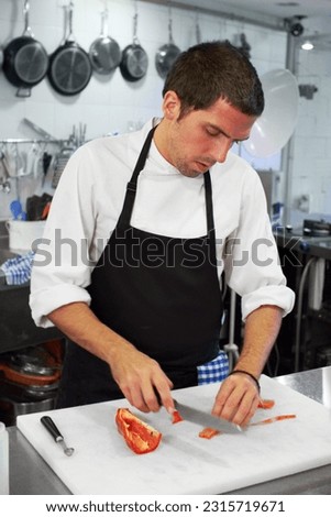 Chef, cooking and cutting with man in kitchen for luxury, hospitality and food catering. Fine dining, gourmet and dinner with male cook in hotel restaurant for menu, cuisine and meal preparation