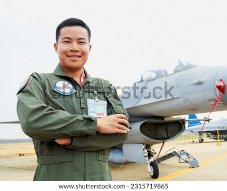 Portrait of asian man, fighter pilot with jet and confident smile at airforce base with arms crossed in Korea. Freedom, transport and proud Asian soldier with airplane, confident and service in army. Royalty-Free Stock Photo #2315719865