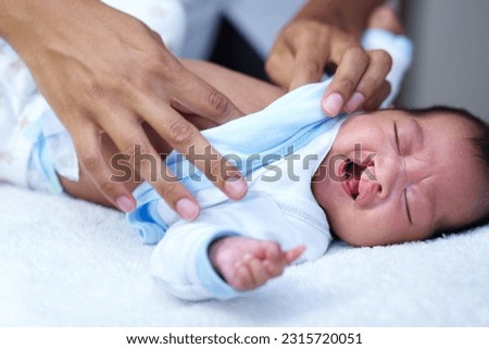 Newborn, cleft palate and mother care for a baby crying in a home bed feeling tired in a bedroom or medical centre. Health, healthcare and young child or kid sad and parent give love and comfort Royalty-Free Stock Photo #2315720051