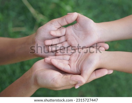Mother and Child’s holding hands to receive something