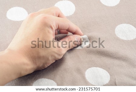 man hand touching cotton fabric textile background