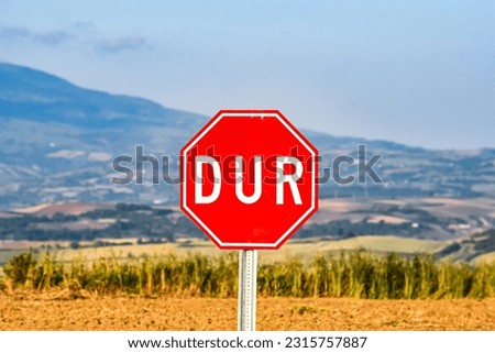 Red traffic sign "Stop" on the nature background